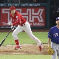 Los Angeles designated hitter Shohei Ohtani bats against Texas in the fourth inning on Monday. AL Player of the Week Ohtani continues hit streak
