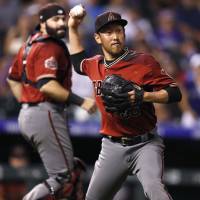Arizona reliever Yoshihisa Hirano throws to first base against Colorado in the ninth inning on Wednesday night. D-Backs closer Yoshihisa Hirano blows save in ninth against Rockies