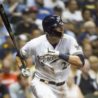 The Brewers’ Christian Yelich smacks a sixth-inning triple against the Reds on Monday at Miller Park. Brewers' Christian Yelich hits for historic cycle against Reds