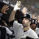 The Yankees' Neil Walker is congratulated by his teammates after hitting a three-run homer against the Red Sox during the eighth inning on Tuesday in New York. The Yankees won 3-1.