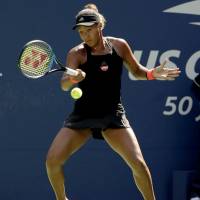 Naomi Osaka returns a shot from Belarus’ Aryna Sabalenka in their fourth-round match at the U.S. Open on Monday. Naomi Osaka shows grit in fourth-round victory over Aryna Sabalenka