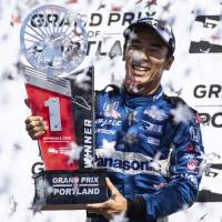 Takuma Sato celebrates with the winner’s trophy after racing to victory in the Portland Grand Prix on Sunday. Takuma Sato holds off Ryan Hunter-Reay to win Portland Grand Prix