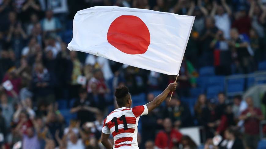 Japan’s Kotaro Matsushima waves a Japanese flag following the Brave Blossom’s shocking win over South Africa during the 2015 Rugby World Cup on Sept. 19, 2015, in Brighton, England. Ticket sales brisk as Japan prepares for rugby mania