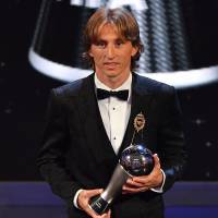 Real Madrid and Croatia midfielder Luka Modric poses for photographers after winning the trophy as FIFA Men’s Player of the Year in London on Monday night. Luka Modric voted FIFA World Player of the Year