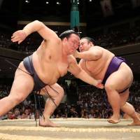 Yokozuna Kisenosato (left) competes against Takakeisho on Monday, the second day of the Autumn Grand Sumo Tournament. Kisenosato keeps comeback on track with impressive Day 2 win