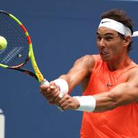 Rafael Nadal plays a shot from Russia’s Karen Khachanov in their third-round match at the U.S. Open on Friday. Rafael Nadal battles past Karen Khachanov in third-rond encounter
