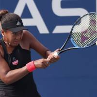Naomi Osaka hits a return during her match against Aliaksandra Sasnovich at the U.S. Open on Saturday in New York. Naomi Osaka rolls through Aliaksandra Sasnovich 6-0, 6-0 at U.S. Open