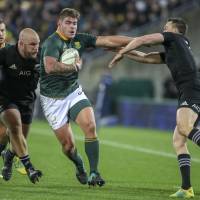 South Africa’s Malcolm Marx fends a tackle by New Zealand’s Ben Smith (right) during a Rugby Championship test match on Saturday in Wellington. Springboks stun All Blacks in Rugby Championship encounter
