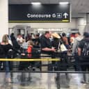 Passengers line up at Miami International Airport's Concourse G on Friday, a day before the concourse was to close for three days due to a shortage of security agents.