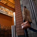 A pedestrian passes the National Debt Clock on West 43rd Street in New York on Friday.