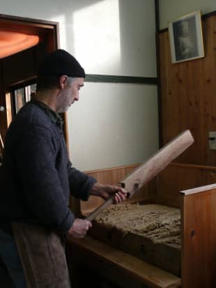 Rogier Uitenboogaart mashes fiber into a pulp before putting it into water.