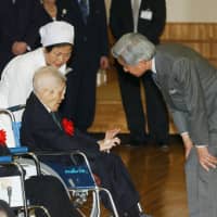 EmperorAkihito bends down to speak with a resident of the state-run leprosy sanatorium  Miyako Nanseien on Miyakojima Island in Okinawa Prefecture on Jan. 25, 2004. | KYODO