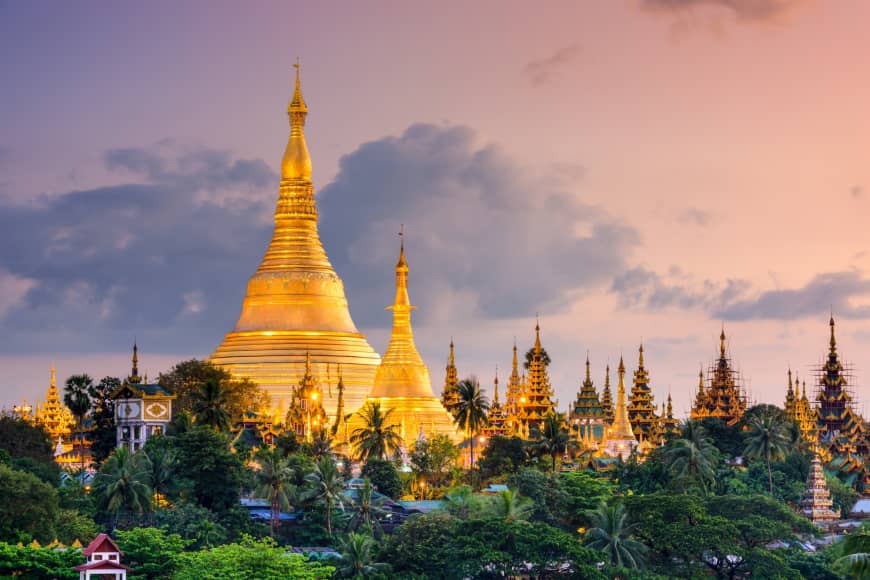 The Shwedagon Pagoda overlooks Yangon at dusk. | GETTY IMAGES