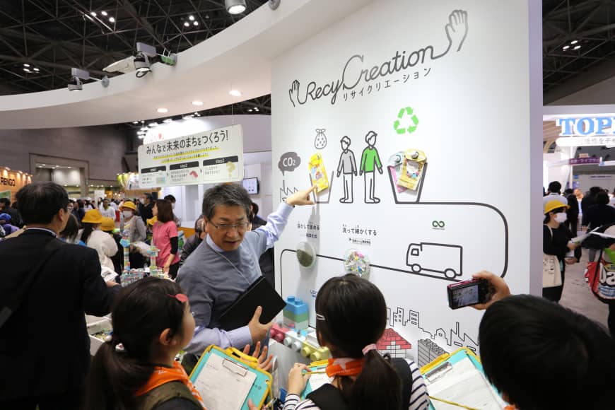 A man explains RecyCreation, an initiative of Kao Corp., to facilitate the younger generation