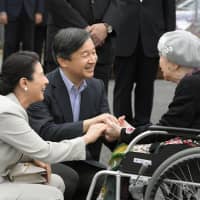 Then-Crown Prince Naruhito and then-Crown Princess Masako visit a temporary housing shelter on Sept. 26 in Asakura, Fukuoka Prefecture, after torrential rains hit the area in July 2017. | KYODO
