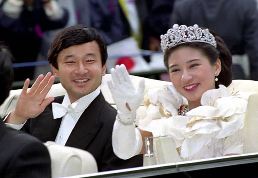 Then-Crown Prince Naruhito and then-Crown Princess Masako wave during their wedding parade on June 9, 1993.