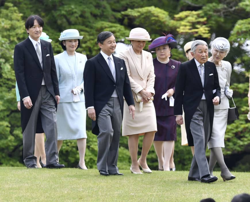 Members of the imperial family walk together at an imperial garden party in April 2018.