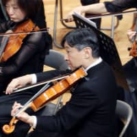 Then-Crown Prince Naruhito plays viola at a concert in an orchestra of Gakushuin University graduates in Tokyo on Dec . 9, 2018. | KYODO