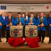 European Union Ambassador Patricia Flor (third from right) and Japanese dignitaries break open sake barrels at a ceremony marking the entry into force of the EU-Japan economic partnership agreement on Feb. 1. | YASUHIKO SHIMAZU, EUROPEAN UNION