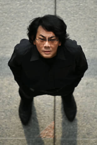 Robotician Hiroshi Ishiguro poses at his research center in Osaka in June. | AFP-JIJI
