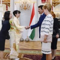 Princess Kako and President Janos Ader shake hands in Budapest on Sept. 20. | KYODO