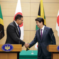 Jamaican Prime Minister Andrew Holness and Japanese Prime Minister Shinzo Abe at their joint press briefing in Tokyo last month.