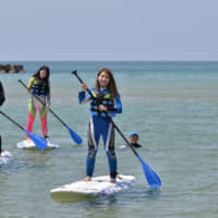 Stand-up paddleboarding is a popular aquatic activity offered in Kyotango. | KYOTANGO CITY TOURISM ASSOCIATION