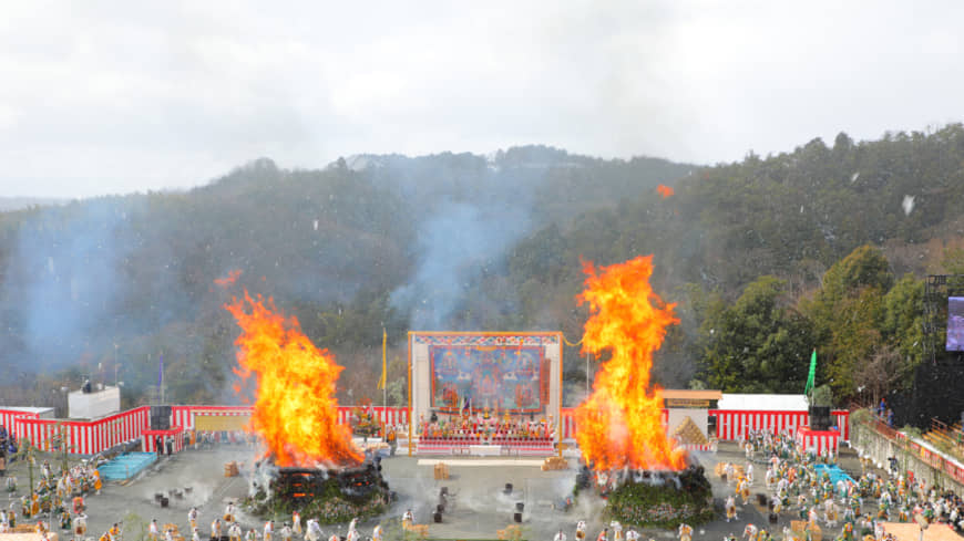 After lighting, bright orange flames burst out of the two gomadan pyres at the center of the amphitheater at the Agon Shu Fire Rites Festival in Kyoto on Feb. 9. | AGON SHU