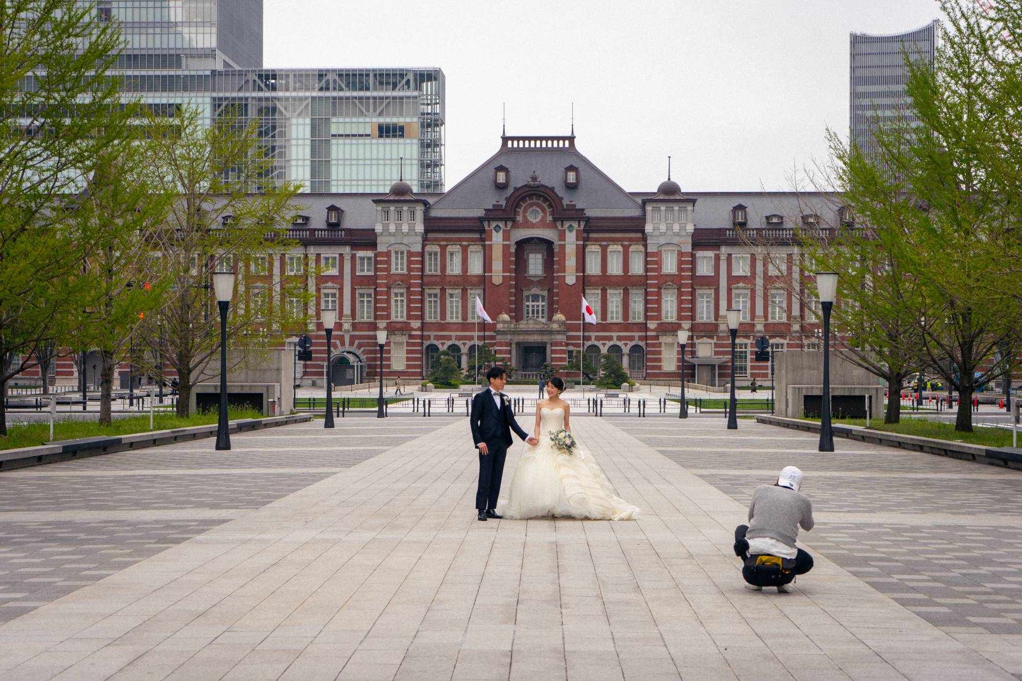 While the state of emergency forced an abrupt change to most people’s lives, some saw the empty city as an opportunity. Here a couple uses an empty Tokyo Station as a backdrop for their wedding photos. On average, more than 500,000 people use Tokyo Station every day. | OSCAR BOYD