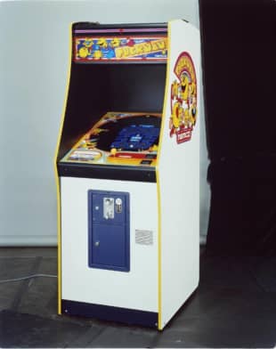 Visitors examine a Pac-Man Micro Player during an electronics expo in Los Angeles in June 2019. | BLOOMBERG