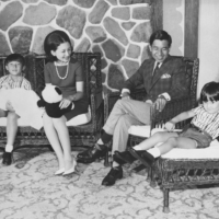 Crown Prince Akishino (far left) holds his younger sister and former Princess Sayako with Empress Emerita Michiko (second from left), Emperor Emeritus Akihito (second from right) and Emperor Naruhito sitting along with them on Aug. 12, 1969, in Karuizawa, Nagano Prefecture. | KYODO