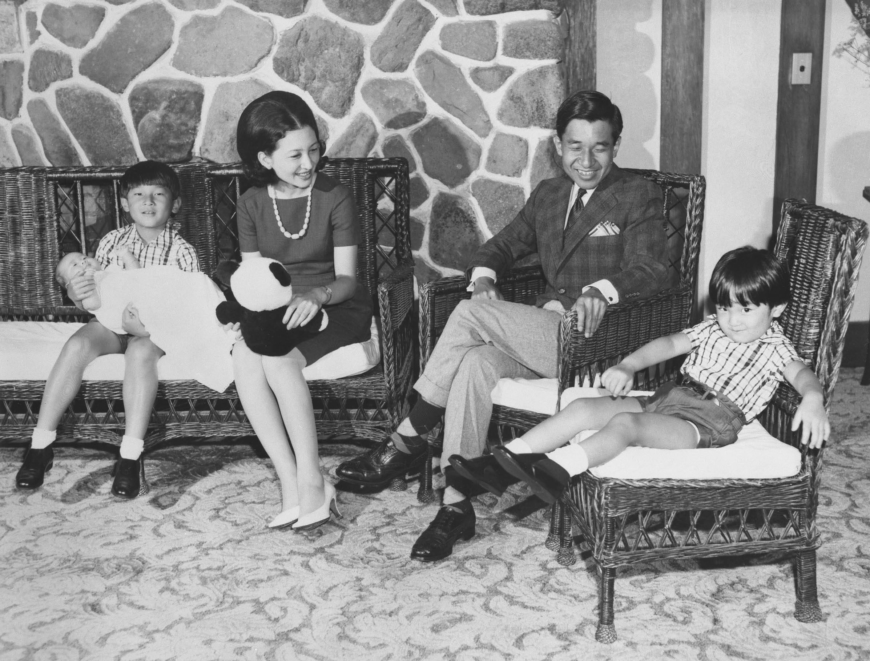 Crown Prince Akishino (far left) holds his younger sister and former Princess Sayako with Empress Emerita Michiko (second from left), Emperor Emeritus Akihito (second from right) and Emperor Naruhito sitting along with them on Aug. 12, 1969, in Karuizawa, Nagano Prefecture. | KYODO