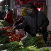 Buyers buy vegetables at a market in Shenyang, China, earlier this month.  President Xi Jinping launched a high-profile campaign against food waste in the summer, seeking to eradicate the deep practice of ordering too many dishes in restaurants as a testament to wealth and generosity.  |  AFP-JIJI