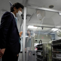 Labor minister Norihisa Tamura visits Kawasaki Heavy Industries’ Tokyo Robot Centre in Tokyo on Jan. 19. Retroactive aid payments eyed for big Japanese firms' nonregular workers