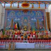 The elaborately decorated altar includes a large Mandala tapestry from Bhutan. | 
