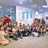 Corrado Mautone (center) raises hands with JTI Vietnam employees during the Rise Up program, one of the company’s employee-engagement activities.