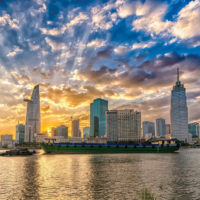 Ho Chi Minh City, Vietnam - February 14th, 2017: Riverside City sunset clouds in the sky at end of day brighter coal sparkling skyscrapers along beautiful river in Ho Chi Minh City, Vietnam