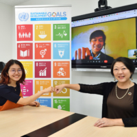  No Youth No Japan leader Momoko Nojo, environmental expert Seita Emori (on monitor) and United Nations Information Centre Director Kaoru Nemoto bump fists after their discussion in September. | YOSHIAKI MIURA