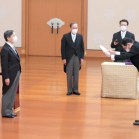 Prime Minister Fumio Kishida bows to Emperor Naruhito (left) during his formal inauguration ceremony at the Imperial Palace in Tokyo on Oct. 4 as his predecessor Yoshihide Suga (center) looks on. | KYODO