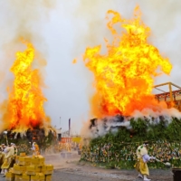 Bright orange pillars of fire burst from two gomadan pyres at the Agon Shu Fire Rites Festival in Kyoto on Feb. 13.