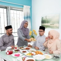 A Malaysian Muslim family enjoys a home Eid al-Fitr celebration. | GETTY IMAGES