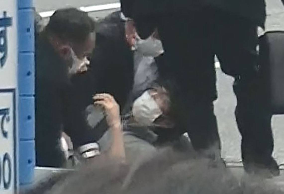 Yamagami is held down by security personnel after allegedly shooting Abe on Friday in Nara. | KYODO