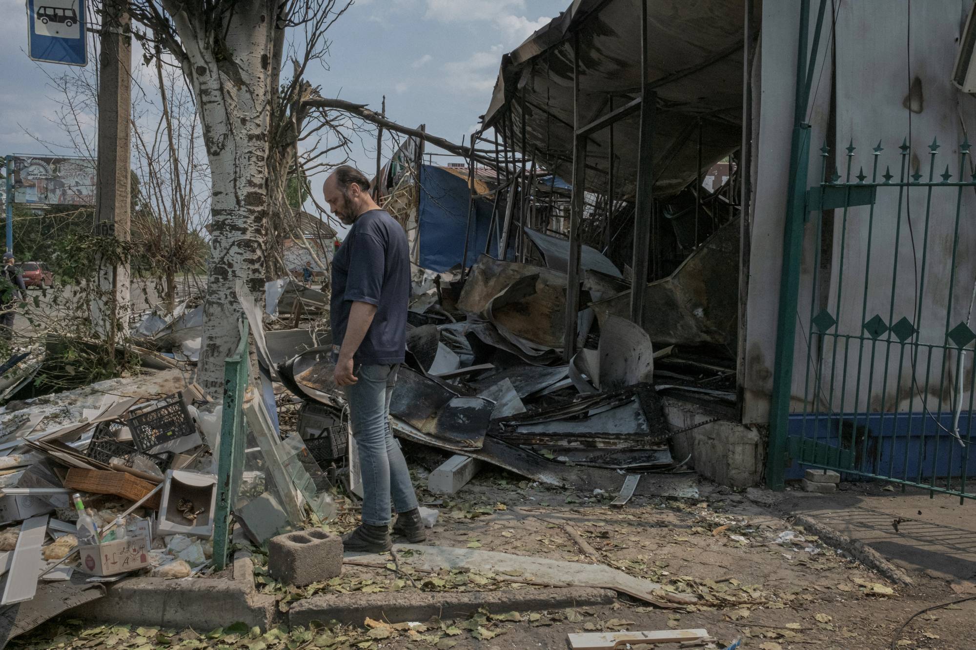 A resident walks by the entrance of a destroyed bazaar hit by shelling Saturday in Bakhmut, Ukraine, on Saturday, where Russian troops are trying to advance. Bakhmut has been battered by shelling this week, as Russia seeks to take the remaining Ukrainian-held areas of Donetsk province. | MAURICIO LIMA / THE NEW YORK TIMES