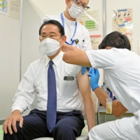 Prime Minister Fumio Kishida gets vaccinated with his fourth COVID-19 shot on Friday in Tokyo.