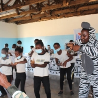 Participants in a hygiene education campaign in Zambia dance to "PPAP-2020" to help combat COVID-19 under guidance from the Japan International Cooperation Agency. | JICA