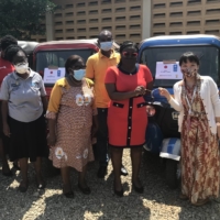 UNDP staff member Yoko Reikan (right) hands over keys to vehicles that will be used by the Ghana Health Service to support remote communities. | UNDP