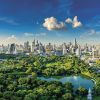 Sunset scence of modern office buildings and condominium in Bangkok city downtown with sunset sky and clouds at Bangkok , Thailand. Lumpini park