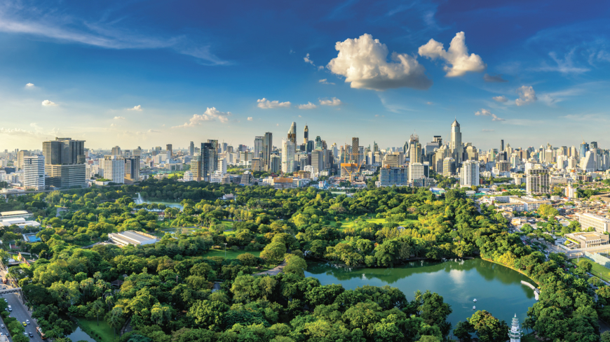 Sunset scence of modern office buildings and condominium in Bangkok city downtown with sunset sky and clouds at Bangkok , Thailand. Lumpini park