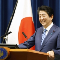 Then-Prime Minister Shinzo Abe addresses the media at his office in Tokyo’s Nagata-cho district on March 14, 2020. | KYODO
