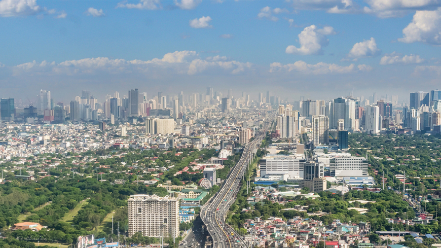 Metro Manila, Philippines - April 2022: The SLEX Skyway going towards the vast Metro Manila cityscape and skyline.